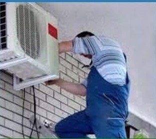 Technician installing an outdoor air conditioning condenser unit