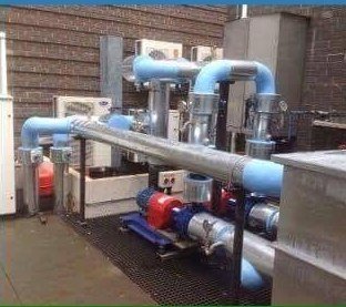 Industrial plant room with pumps, pipework and ventilation systems
